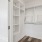 Closet space with shelves and ample lighting